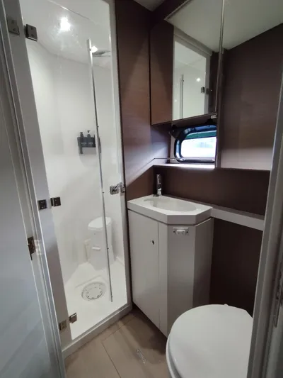 Amura Yacht Photos Pics Compact bathroom in 2021 Bali 5.4 model, featuring shower, sink, and toilet.