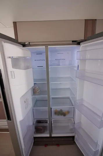 Amura Yacht Photos Pics Open Bali 5.4 refrigerator, 2021 model, with empty shelves and minimal contents.