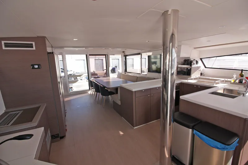 Amura Yacht Photos Pics Luxurious interior of 2021 Bali 5.4 yacht with modern kitchen and dining area.