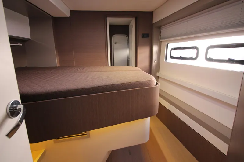 Amura Yacht Photos Pics Modern interior of a 2021 Bali 5.4 yacht cabin with bed and windows.