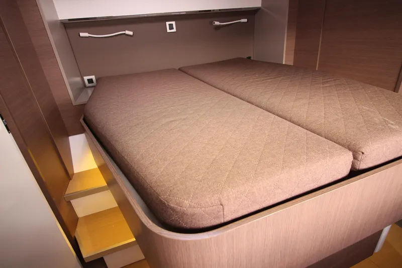 Amura Yacht Photos Pics Interior of 2021 Bali 5.4 yacht with a cozy double bed and wooden steps.
