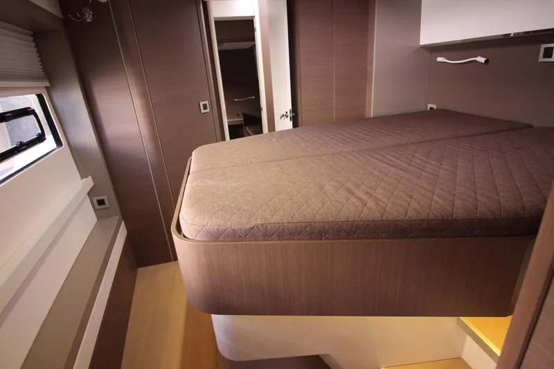 Amura Yacht Photos Pics Modern bedroom interior in a 2021 Bali 5.4 yacht, featuring a raised bed and sleek design.