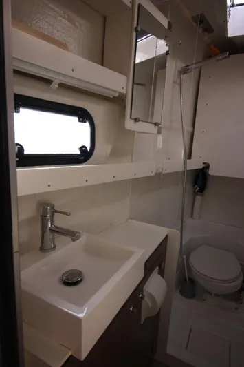 Amura Yacht Photos Pics Compact bathroom in 2021 Bali 5.4 yacht with sink, mirror, and toilet.