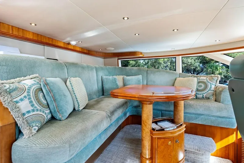Picosa Lady Yacht Photos Pics Luxurious 2001 West Bay Sonship yacht interior with plush seating and elegant wooden table.
