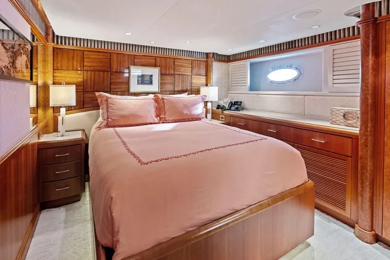 Picosa Lady Yacht Photos Pics Luxurious 2001 West Bay Sonship yacht bedroom with elegant wood paneling and soft lighting.