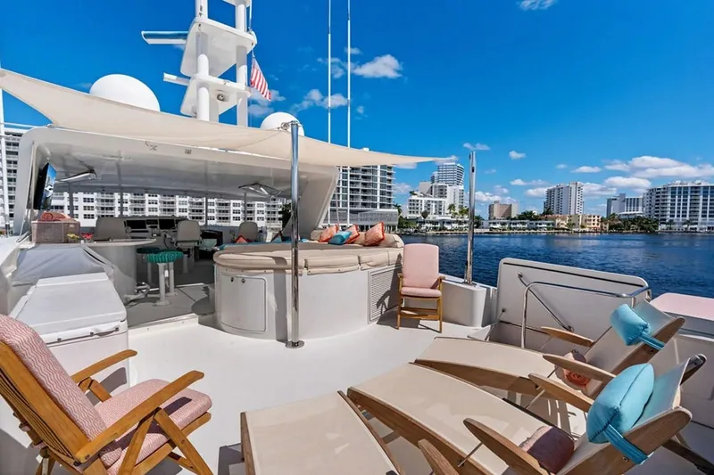 Picosa Lady Yacht Photos Pics Luxurious 2001 West Bay Sonship yacht deck with seating, overlooking waterfront cityscape.