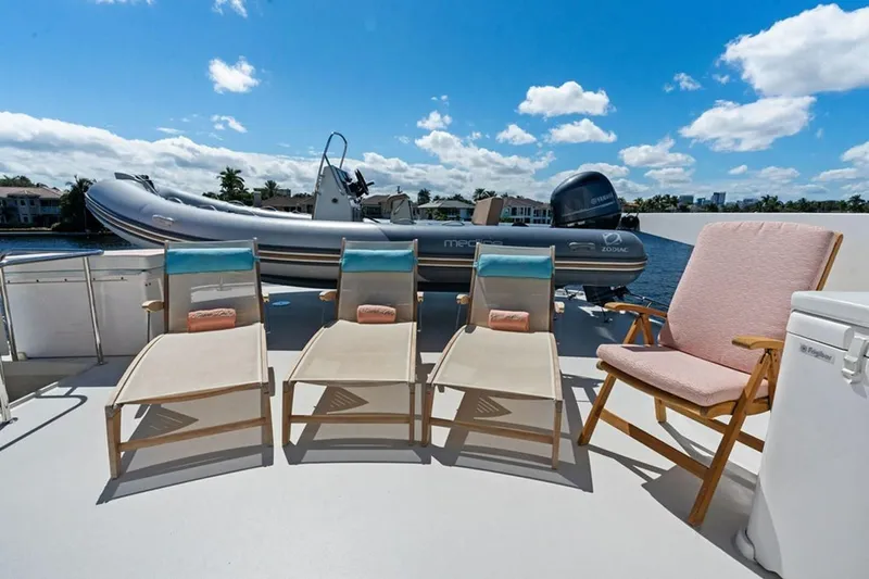 Picosa Lady Yacht Photos Pics Deck of 2001 West Bay Sonship yacht with lounge chairs and inflatable boat.