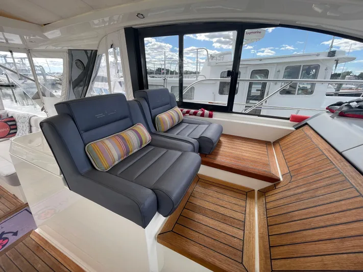 Ohana Yacht Photos Pics 2013 Sealine S450 yacht interior with plush seating and wooden flooring.