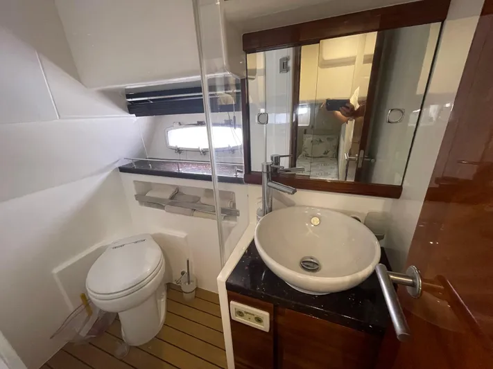 Ohana Yacht Photos Pics Bathroom interior of 2013 Sealine S450 yacht with modern fixtures and wooden accents.