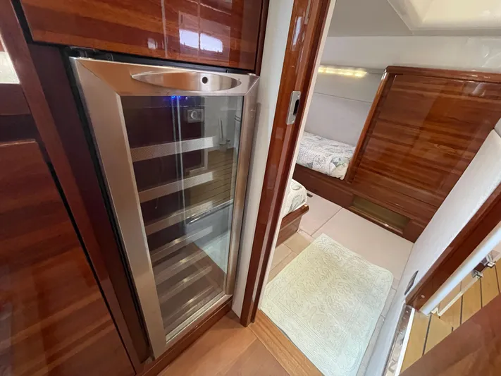 Ohana Yacht Photos Pics Interior of 2013 Sealine S450 yacht featuring a sleek wine cooler and cozy cabin.