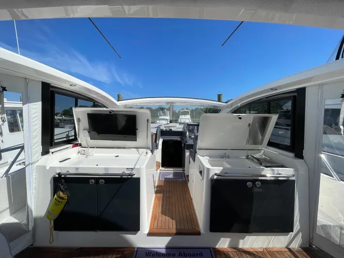 Ohana Yacht Photos Pics 2013 Sealine S450 yacht interior with open cabinets and clear blue sky.