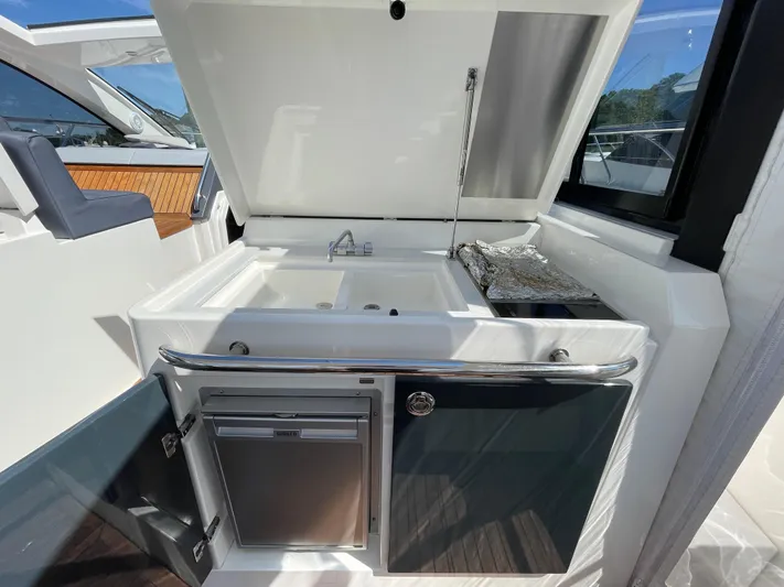 Ohana Yacht Photos Pics Outdoor kitchen on a 2013 Sealine S450 yacht with sink and grill.