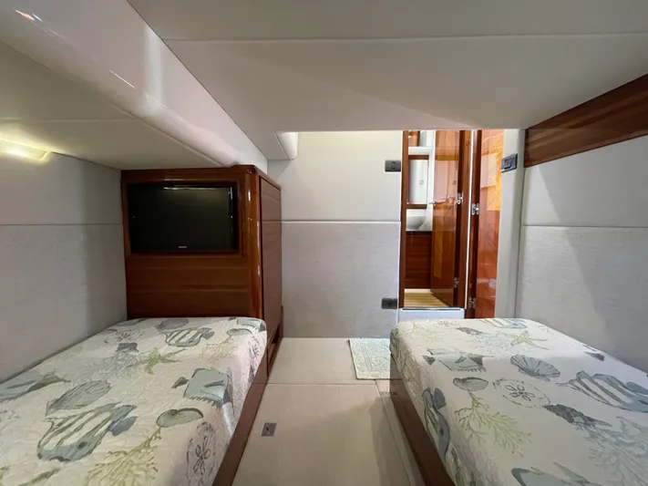 Ohana Yacht Photos Pics Interior of 2013 Sealine S450 yacht with twin beds and a TV.
