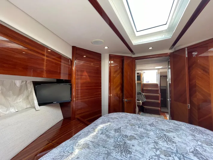 Ohana Yacht Photos Pics Luxurious 2013 Sealine S450 yacht interior with wood paneling, skylight, and TV.