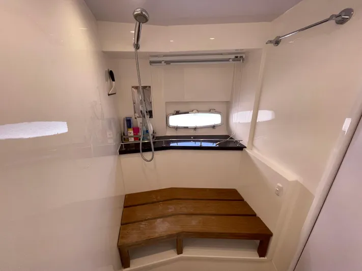 Ohana Yacht Photos Pics Sealine S450 2013 yacht shower with wooden bench and modern fixtures.