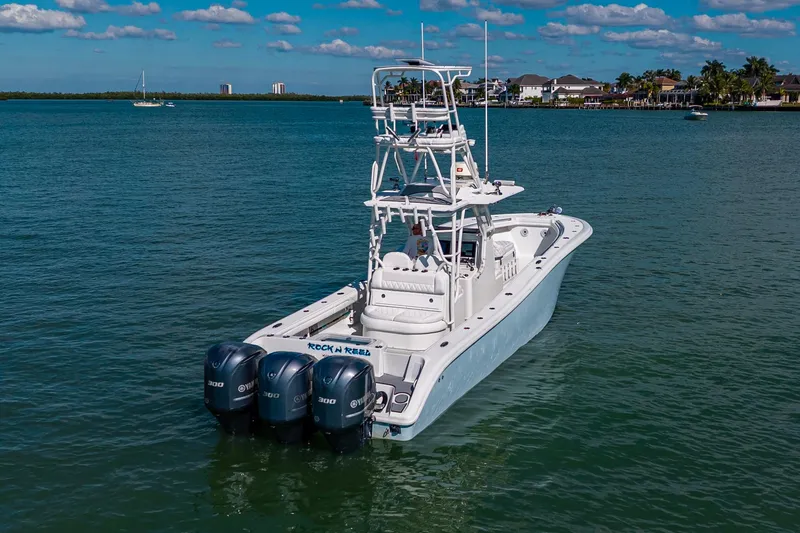 Rock N Reel Yacht Photos Pics 2018 Yellowfin 36 Offshore boat with triple Yamaha engines on calm water.