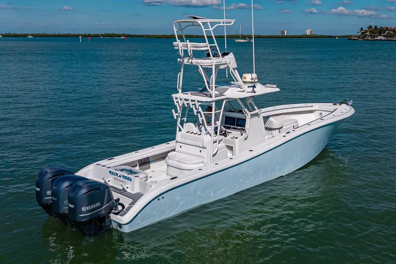 Rock N Reel Yacht Photos Pics 2018 Yellowfin 36 Offshore boat with triple Yamaha engines on calm water.