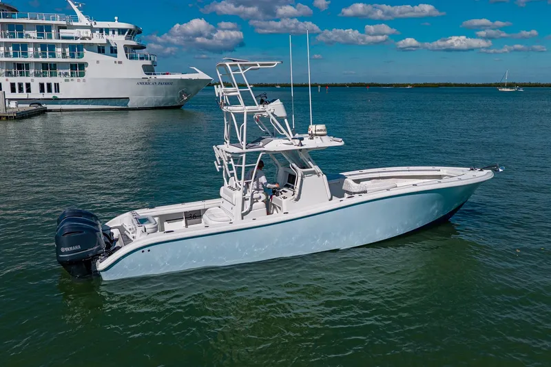 Rock N Reel Yacht Photos Pics 2018 Yellowfin 36 Offshore boat on water, with large ship in background.