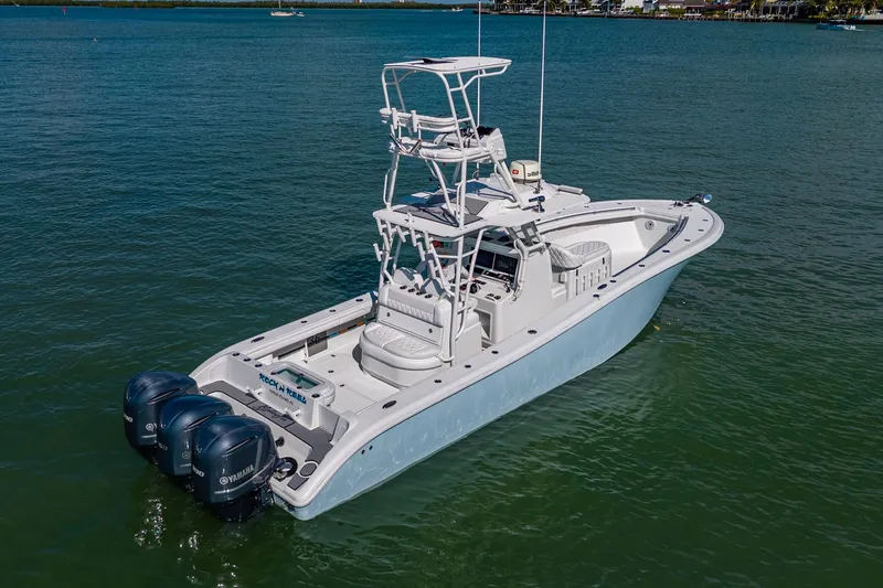 Rock N Reel Yacht Photos Pics 2018 Yellowfin 36 Offshore boat with triple Yamaha engines on calm water.