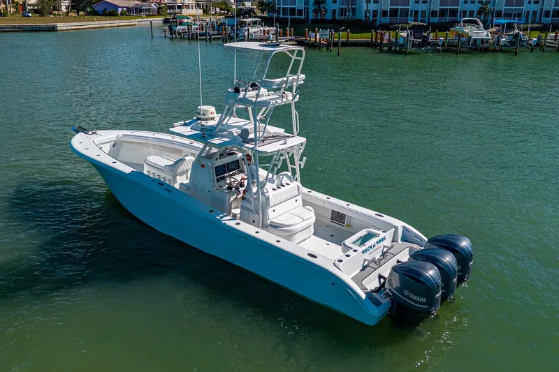 Rock N Reel Yacht Photos Pics 2018 Yellowfin 36 Offshore boat with triple Yamaha engines on calm water.