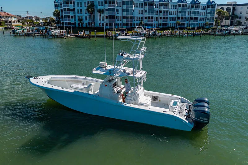 Rock N Reel Yacht Photos Pics 2018 Yellowfin 36 Offshore boat on water near residential buildings.