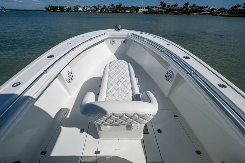 Rock N Reel Yacht Photos Pics 2018 Yellowfin 36 Offshore boat with white seating, on calm water.