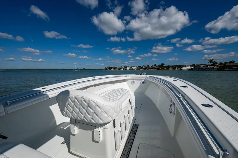 Rock N Reel Yacht Photos Pics 2018 Yellowfin 36 Offshore boat on calm water under a blue sky with clouds.