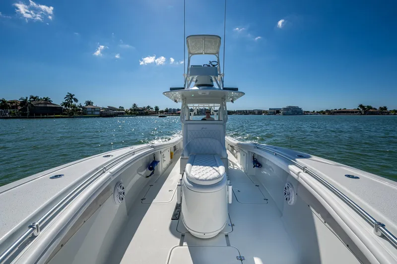 Rock N Reel Yacht Photos Pics 2018 Yellowfin 36 Offshore boat cruising on a sunny day, with clear blue skies.