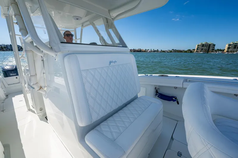 Rock N Reel Yacht Photos Pics 2018 Yellowfin 36 Offshore boat interior with white seating, on a sunny day.