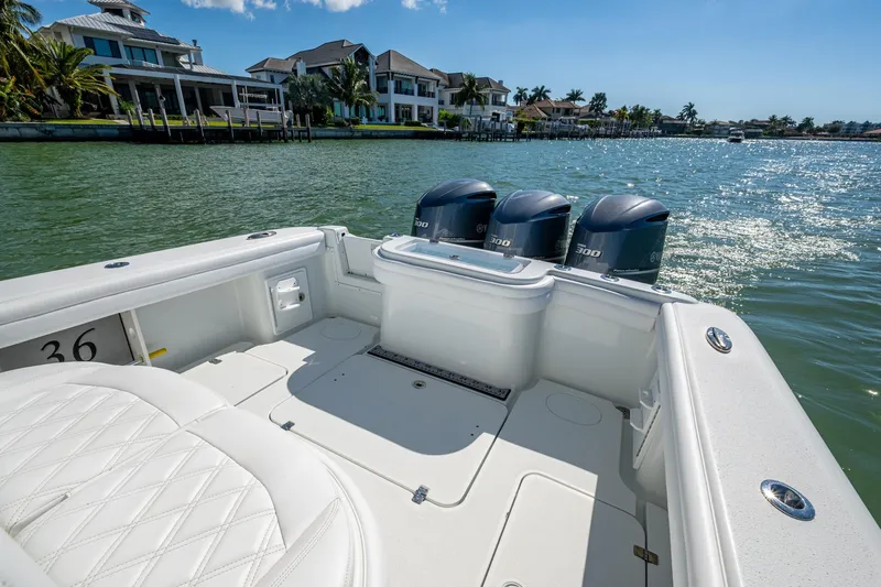 Rock N Reel Yacht Photos Pics 2018 Yellowfin 36 Offshore boat with triple 300 horsepower engines on a sunny waterfront.