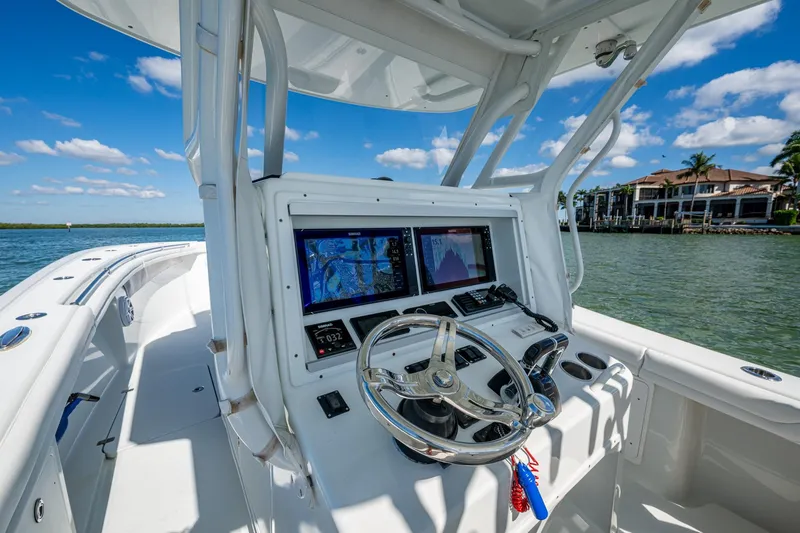 Rock N Reel Yacht Photos Pics 2018 Yellowfin 36 Offshore boat dashboard with navigation screens on a sunny day.