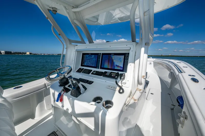 Rock N Reel Yacht Photos Pics 2018 Yellowfin 36 Offshore boat cockpit with navigation screens and steering wheel.