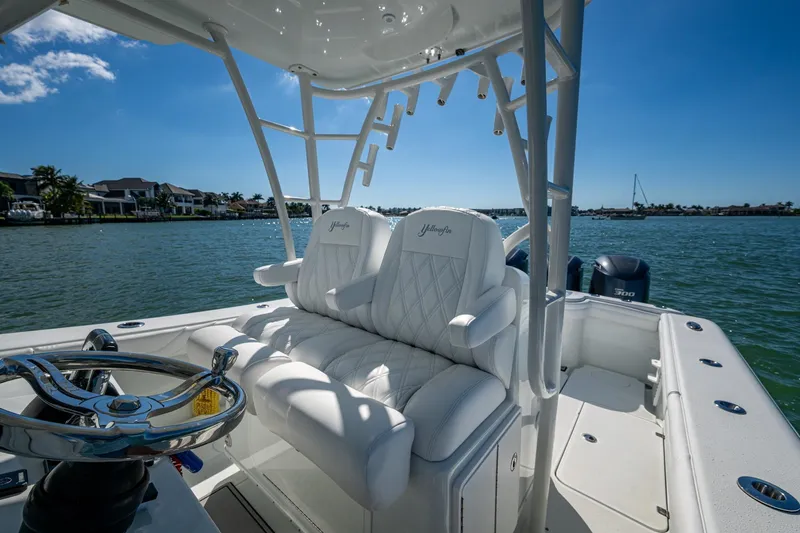 Rock N Reel Yacht Photos Pics 2018 Yellowfin 36 Offshore boat interior with luxurious seating and steering wheel on a sunny day.