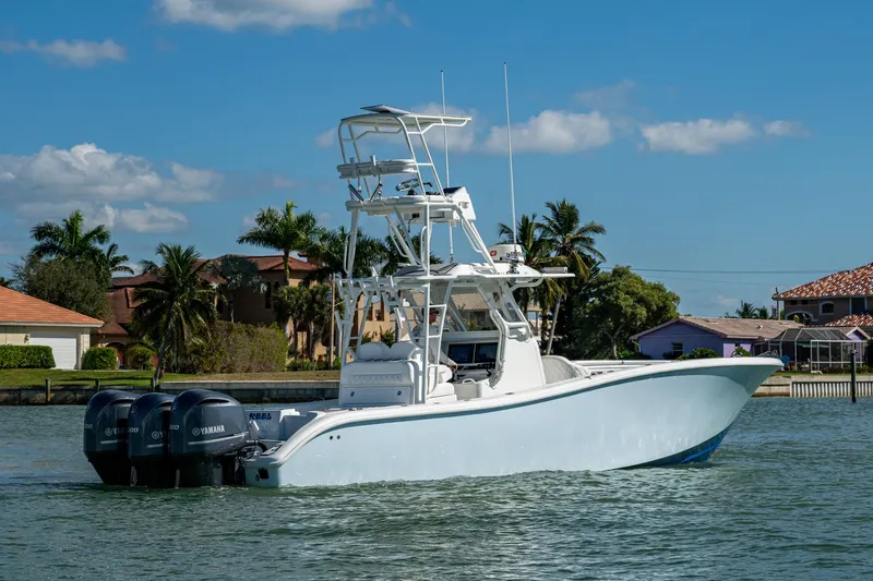 Rock N Reel Yacht Photos Pics 2018 Yellowfin 36 Offshore boat with triple Yamaha engines on a sunny day.