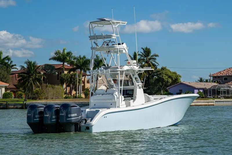 Rock N Reel Yacht Photos Pics 2018 Yellowfin 36 Offshore boat with triple Yamaha engines on a sunny day.