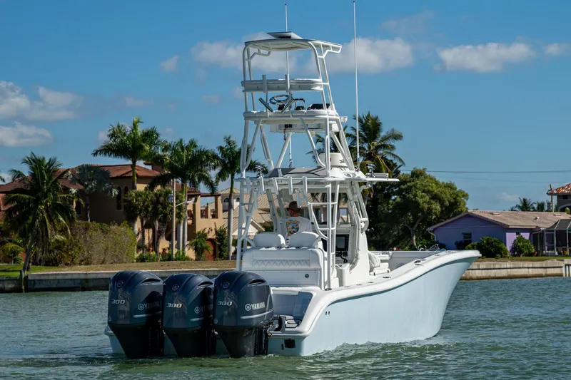 Rock N Reel Yacht Photos Pics 2018 Yellowfin 36 Offshore boat with triple Yamaha engines on a sunny day.