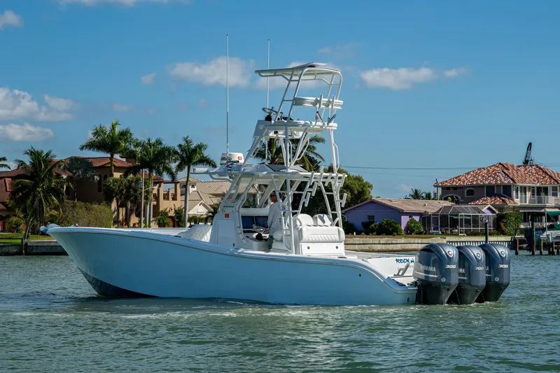 Rock N Reel Yacht Photos Pics 2018 Yellowfin 36 Offshore boat with triple Yamaha engines on a sunny day.