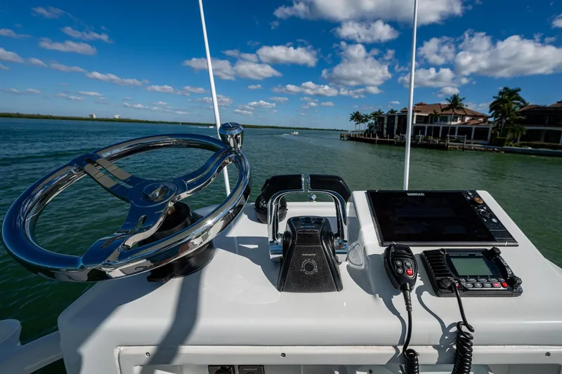 Rock N Reel Yacht Photos Pics 2018 Yellowfin 36 Offshore boat helm with steering wheel and navigation equipment.