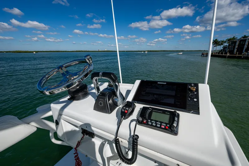Rock N Reel Yacht Photos Pics 2018 Yellowfin 36 Offshore helm with steering wheel, controls, and navigation system.