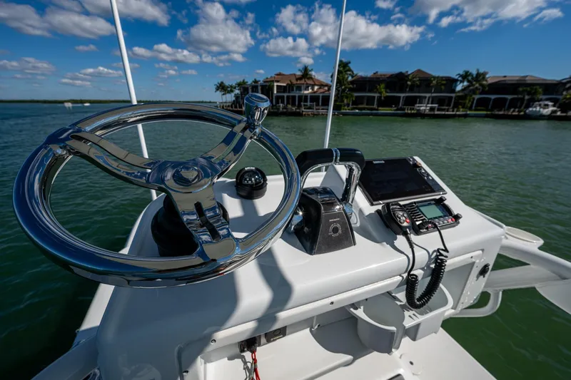 Rock N Reel Yacht Photos Pics 2018 Yellowfin 36 Offshore boat helm with steering wheel and navigation equipment.