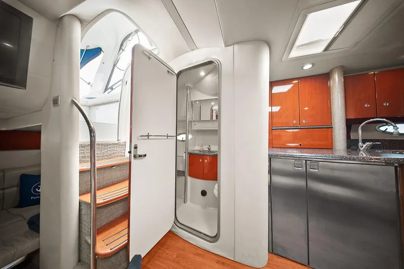 Pura Vida Yacht Photos Pics Interior of 2008 Formula 40 Performance Cruiser with modern kitchen and wooden cabinetry.