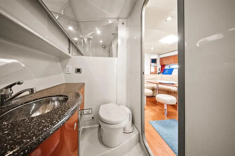 Pura Vida Yacht Photos Pics 2008 Formula 40 Performance Cruiser bathroom with modern sink and toilet, leading to cozy cabin.