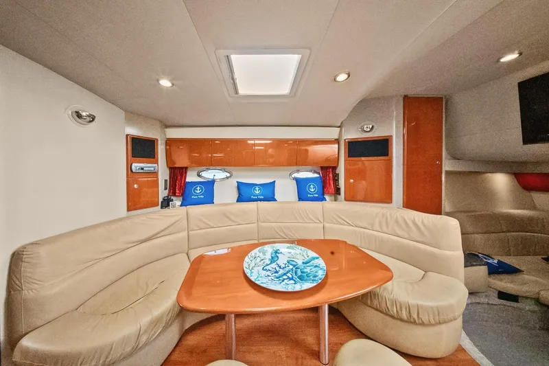 Pura Vida Yacht Photos Pics Interior of 2008 Formula 40 Performance Cruiser with beige seating and wooden table.
