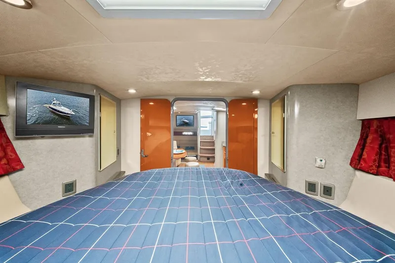 Pura Vida Yacht Photos Pics 2008 Formula 40 Performance Cruiser cabin with bed, TV, and modern interior design.