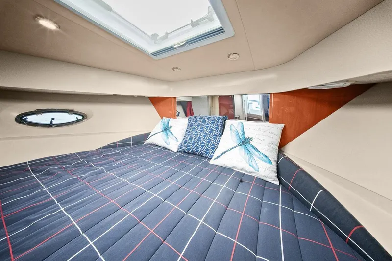 Pura Vida Yacht Photos Pics Interior cabin of 2008 Formula 40 Performance Cruiser with plaid bedding and decorative pillows.
