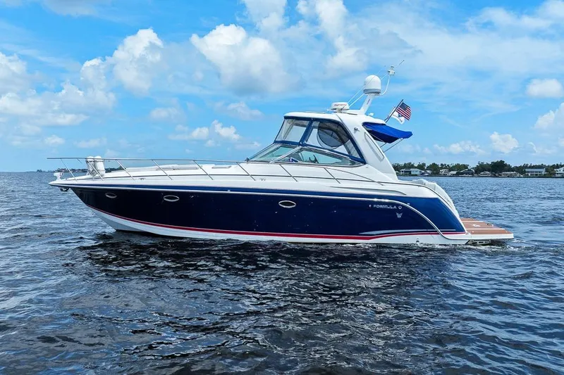 Pura Vida Yacht Photos Pics 2008 Formula 40 Performance Cruiser on open water under blue sky.