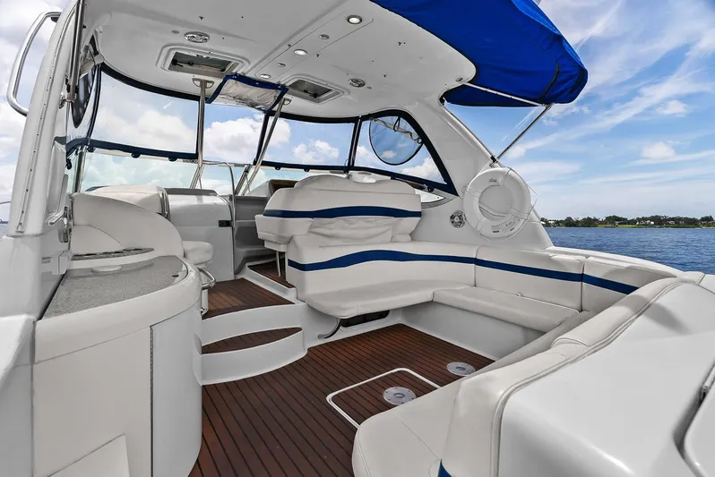 Pura Vida Yacht Photos Pics 2008 Formula 40 Performance Cruiser interior with white seating and blue accents on a sunny day.