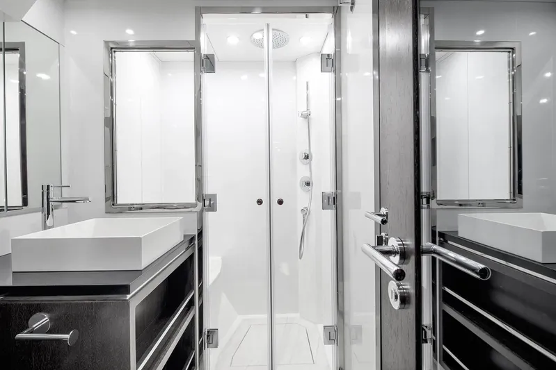  Yacht Photos Pics Luxurious bathroom in 2022 Sirena 68 yacht with modern fixtures and sleek design.