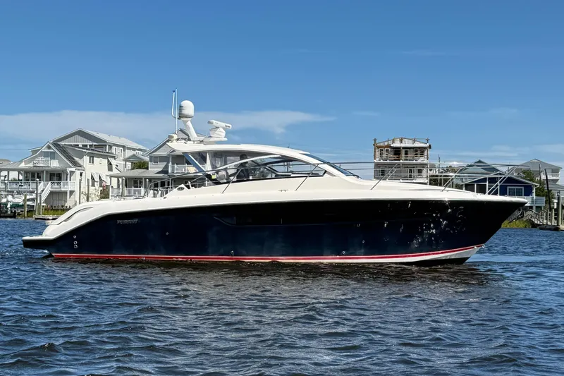  Yacht Photos Pics 2013 Pursuit SC 365i Sport Coupe yacht on water, with coastal homes in background.