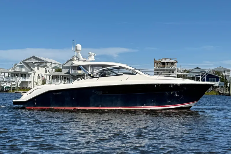  Yacht Photos Pics 2013 Pursuit SC 365i Sport Coupe yacht on water, with coastal homes in background.